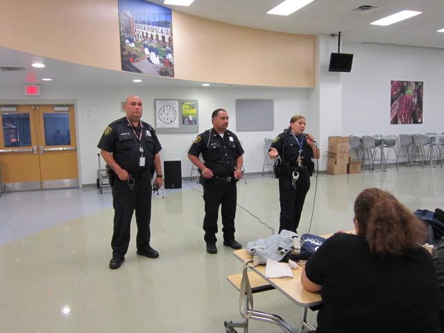 Officer Diaz and fellow officers talking to parents about bullying