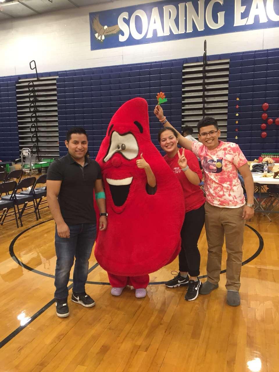 students with blood drop mascot a blood donor