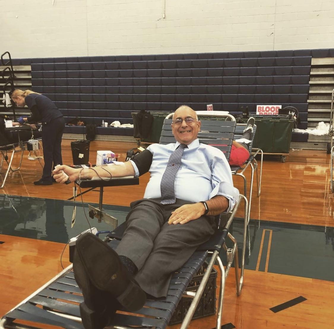 anthony dragona giving blood and smiling
