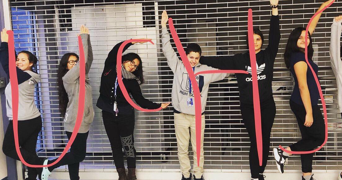 students standing in the shapes of the letters UCHS